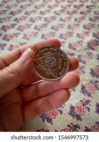 Guadalajara, Mexico - October 29 2019: Hand Holding AA Alcoholics Anonymous Sobriety Chip Awarded For Abstaining From Alcohol Or Other Substances For 24 Hours