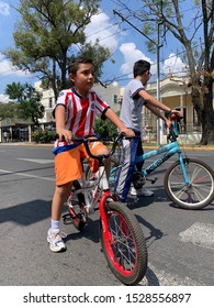 Guadalajara, Mexico - October 6 2019: Male Boy Chivas Soccer Fan On A Bicycle. Via Recreactiva Guadalajara