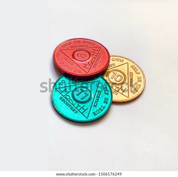 Guadalajara,\
Mexico - September 9 2019: AA sobriety chips awarded for abstaining\
from alcohol or other substance for months. It is a token given to\
12 step group members. Successful\
rehab