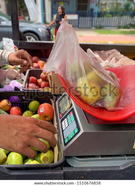 Guadalajara, Mexico - Septiembre 20 2019: Market on\
wheels. Fruit and vegetables for sale on the back of a red pick up\
truck  