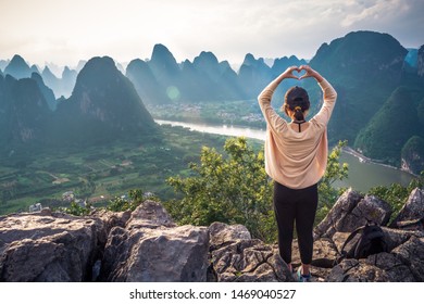 GUANGXI,GUILIN 14 may 2019 - the girl watching Sunset view of the Li River seen from Laozhai Mountain (Laozhai Shan),located at Xingping ancient town,Yangshuo town