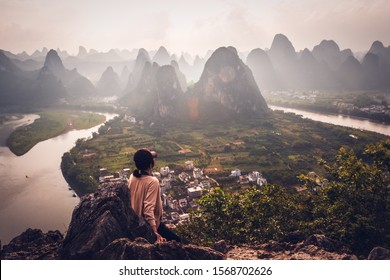 GUANGXI,GUILIN 14 may 2019 - the girl watching Sunset view of the Li River seen from Laozhai Mountain (Laozhai Shan),located at Xingping ancient town,Yangshuo town