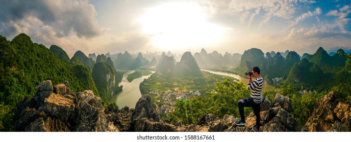 GUANGXI,GUILIN 14 may 2019 - the man 
 watching Sunset view of the Li River seen from Laozhai Mountain (Laozhai Shan),located at Xingping ancient town,Yangshuo town