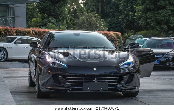 Guangzhou, China- August 16,2022: A black\
Ferrari GT4 LUSSO hypercar is parked in\
street