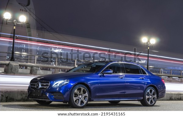 Guangzhou, China- August 18,2022: A\
\
blue Mercedes-Benz E300 L sedan is parked in\
courtyard