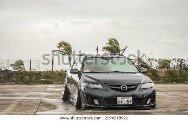 Guangzhou, China- August 18,2022: A grey\
modified Mazda mpv is parked in\
courtyard