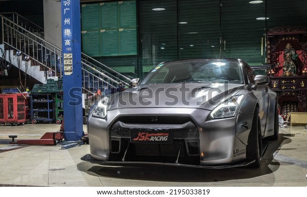 Guangzhou, China- August 18,2022: a grey\
LB modified Nissan GT-R sportcar is parked in\
garage