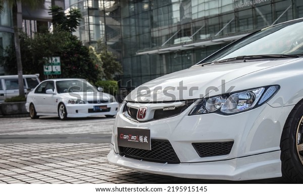 Guangzhou, China- August 18,2022: a white\
modified Honda sedan is parked in\
courtyard