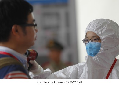 GUANGZHOU, CHINA - OCT. 30. 2014:People have their temperature taken at  Canton Fair. Guangdong province was identified as a front line to prevent the deadly Ebola virus from entering China.