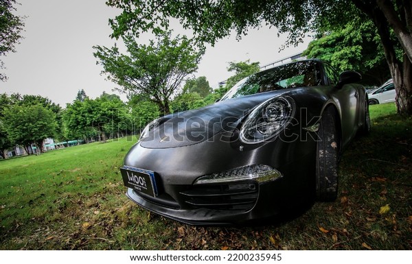 Guangzhou, China- September 1,2022: A black Porsche\
911 sportcar is parked in\
park