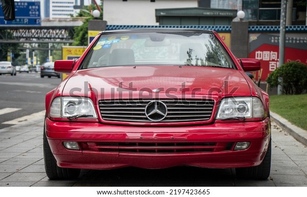 Guangzhou, China- September 1,2022: A red\
Mercedes-Benz SL320 coupe is parked in\
street