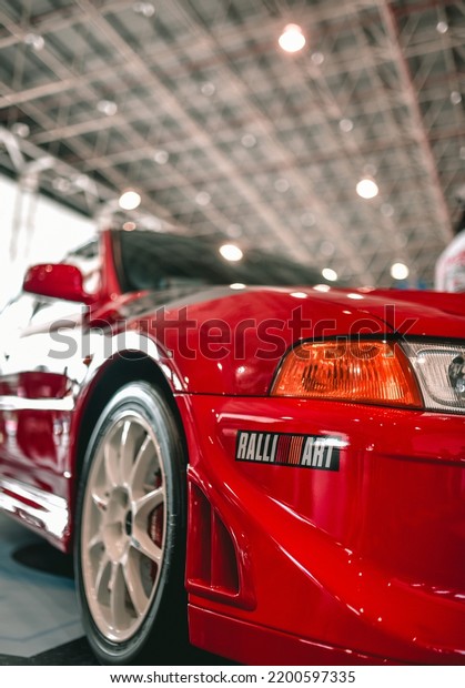 Guangzhou, China-\
September 1,2022: A red Mitsubishi Evolution 6.5 TME sportcar is\
parked in showroom