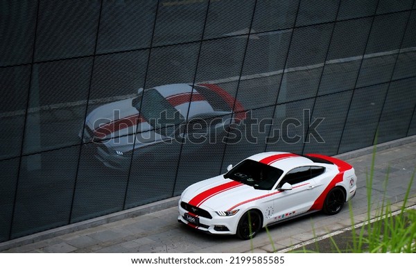 Guangzhou, China- September 1,2022: A white\
Ford Mustang sportcar is parked in\
courtyard
