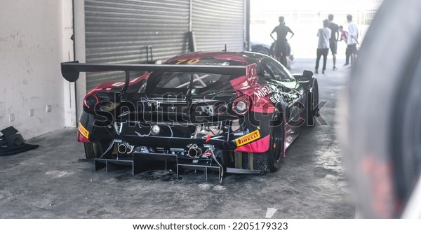 Guangzhou, China- September 18,2022: A black\
Ferrari hypercar is parked in\
garage