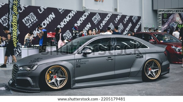 Guangzhou, China- September 18,2022: A grey\
modified Audi sedan is parked in showroom\
