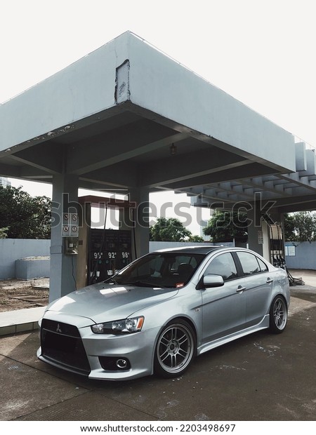 Guangzhou, China- September 18,2022: A silver\
Mitsubishi sportcar is parked in gas\
station