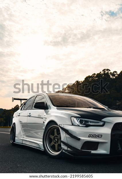 Guangzhou, China- September 8,2022: A\
white Mitsubishi Lancer EX sportcar is parked on\
road
