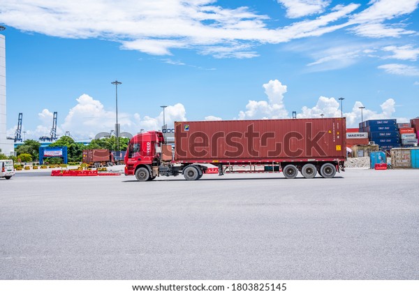 Guangzhou, China-August 15, 2020: Busy container\
transport trailers at the Nansha Sea Port Container Terminal in\
Guangzhou Port