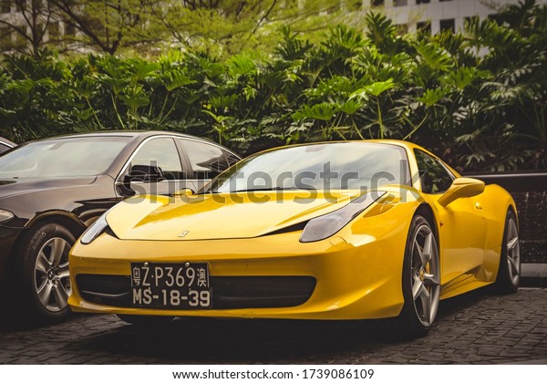 Guangzhou, year 2019:\
Front view of a yellow Ferrari 458 Italia parked in a luxury hotel.\
Italian supercar.