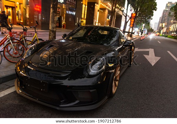 Guangzhou, year 2019: view of a black\
Porsche 911 GT3RS parked on the street. German\
supercar.