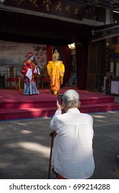 Guangzhou,china - Aug,16,2017: Old Man Watching Contonese Opera Show With Moblie.