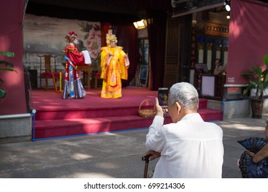 Guangzhou,china - Aug,16,2017: Old Man Watching Contonese Opera Show With Moblie.