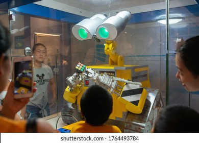 Guangzhou,China-August 4,2018:people Watching A Robot Playing A Rubik's Cube In A Science Museum.