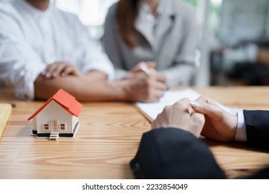 Guarantee, Mortgage, agreement, contract, Signing, Male client holding pen to reading agreement document to sign land loan with real estate agent or bank officer - Shutterstock ID 2232854049