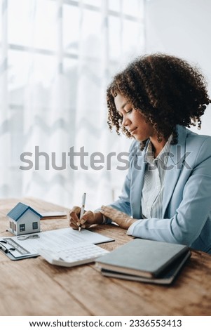 Guarantee, Mortgage, agreement, contract, Signing,woman african american client holding pen to reading agreement document to sign land loan with real estate agent or bank officer, insurance concepts.