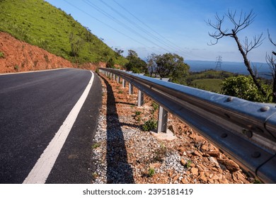 The guard rail, barrier on wayside with cloudy and hill. the straight line from highway fence. image from background, highway fence