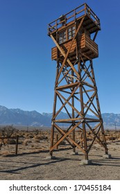 Guard tower with a search light in the desert by the mountains