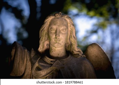 Guardian Angel Against Dark Background. (fragment Of An Antcient Statue.