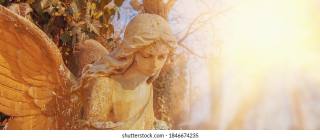 Guardian Angel. Ancient Stone Statue In Sunlight. Copy Space For Design.