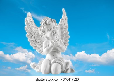 Guardian Angel On Blue Sky Background. Religion And Faith Concept