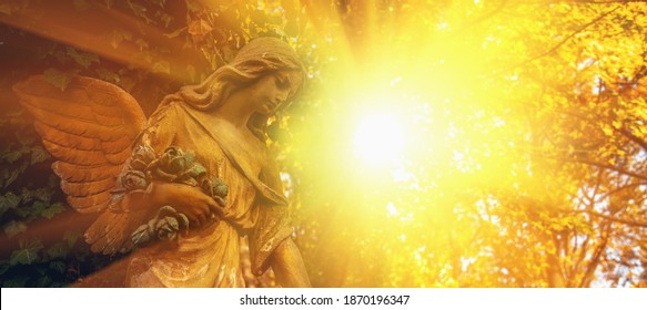 Guardian Angel Statue In Sunlight. Horizontal Image.