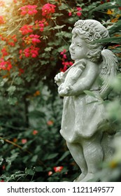 Guardian Angel Statue In Sunlight As A Symbol Of Love In Garden