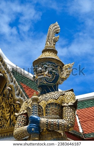 Guardian demon at the gate wat pra kaew in bangkok, thailand, public art, public art, giant demon in emerald buddha temple thailand in blue sky