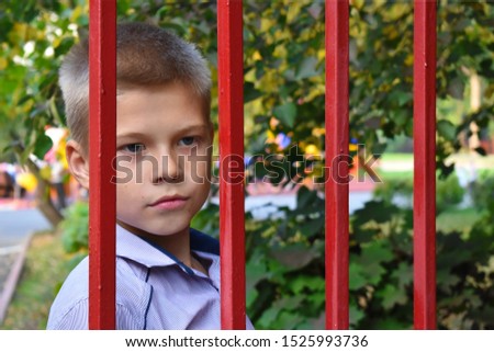 Guardianship authorities select children. Juvenile justice. Deprivation of parental rights. A child in captivity. A teenager looks through a trellised fence. Orphanage. Take a child an orphan.