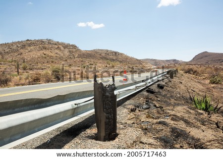 Guardrail posts destroyed by fire along an Arizona highway