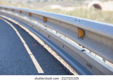 Guardrails poles covered crash-absorber beam. Shoulder view. Motorists safety concept