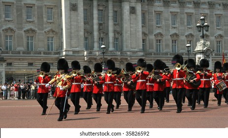 a guards band marching in front of buckingham palace