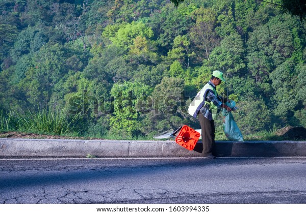 Guatemala , Guatemala City –\
5/31/18. Municipal worker man in charge of cleaning in the streets\
of Guatemala City, work effort from dawn on Calzada La Paz.\
Editorial