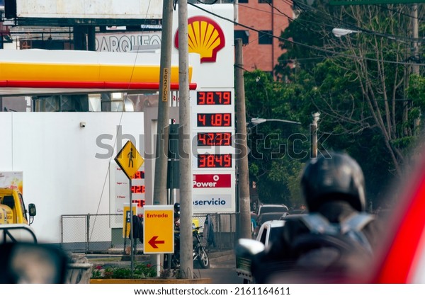 Guatemala city, Guatemala; May 16 2022: Gas\
station sign with prices in Quetzales, Guatemalan currency,\
exchange rate with the dollar 7.67, high prices and congested\
traffic in the city.\
Editorial
