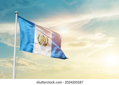 Guatemala national flag waving in beautiful clouds.