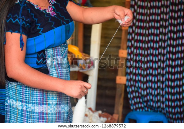 Guatemalan woman weaving traditional textiles from\
raw cotton