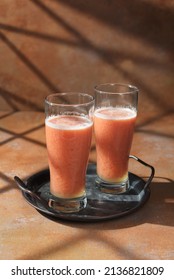 Guava juice is a healthy drink made from a mixture of various fruits and vegetables, red guava, pineapple, carrot and squeezed orange. Served in a glass on the table. Selective focus