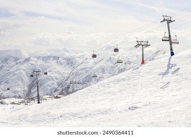 Gudauri Ski Resort: Gondola (Ski Lift) and Snow-covered Caucasus Mountains in Distance - Gudauri, Georgia. - Powered by Shutterstock