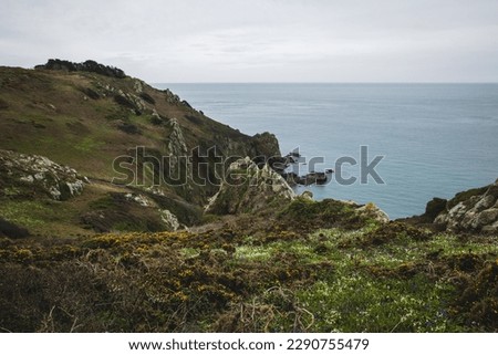 Guernsey south coast - a view across the cliffs to the water on a beautiful overcast day in the Channel Islands.