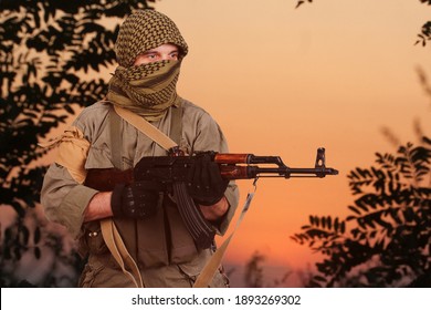 Guerrilla Warfare. Insurgent With AK 47 Rifle In Forest.