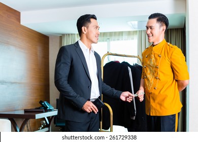 Guest Giving Tip To A Bell Boy In Hotel Room